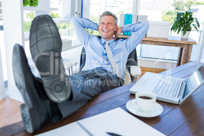 Businessman relaxing in a swivel chair