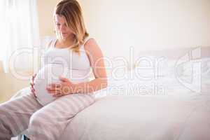 Pregnant woman looking at her belly