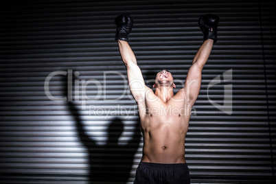 Muscular man punching in the air