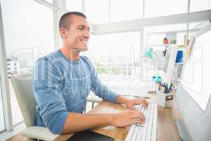 Young creative businessman typing on the computer