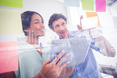 Puzzled business team looking post its on the wall