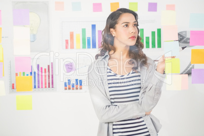 Pretty designer looking at post its on window
