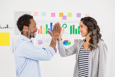 Young smiling business people clapping hands