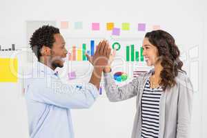 Young smiling business people clapping hands