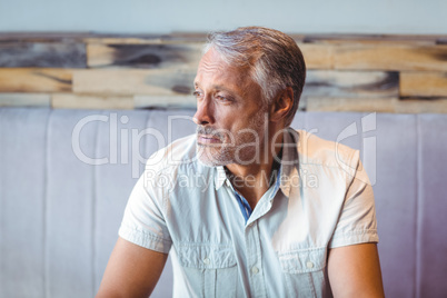 Thoughtful man looking away in coffee shop
