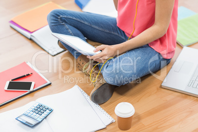 Young creative businesswoman scrolling on tablet