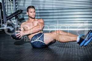 Muscular man doing exercise with medicine ball