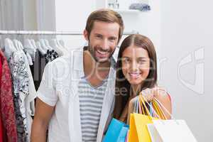 Portrait of smiling couple with shopping bags