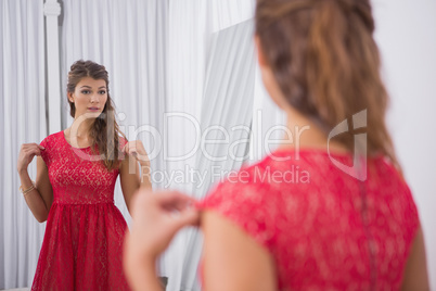 Woman trying on a red dress