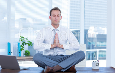 Zen businessman doing yoga meditation