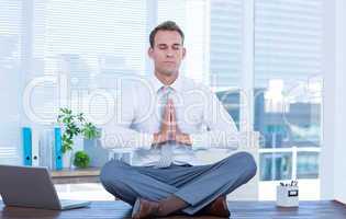 Zen businessman doing yoga meditation