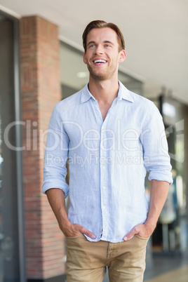 Happy smiling man with his hands in his pocket