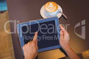 Close-up of digital tablet and coffee on table