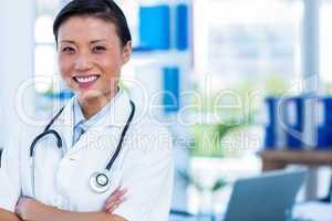 Confident doctor with arms crossed smiling at camera