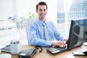 Smiling businessman using computer