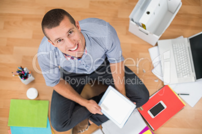 Young creative businessman working on tablet