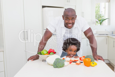 Little boy cooking with his father