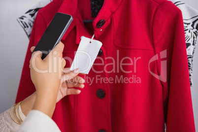 Woman taking a photo of price tag