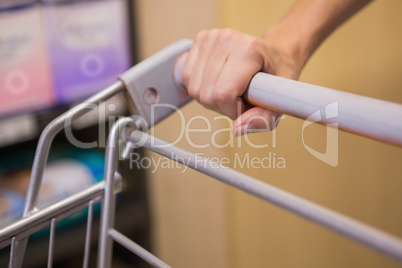 Hand of woman putting on trolley