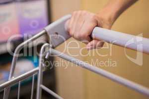 Hand of woman putting on trolley