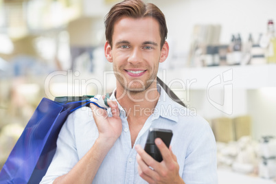 A happy smiling man looking at the phone