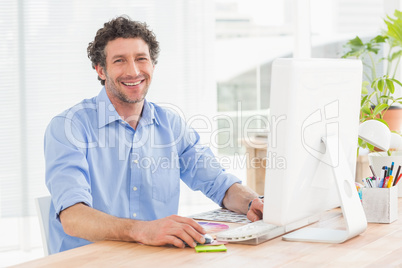 Casual businessman using computer in office Casual businessman using computer in office