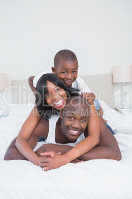 Pretty couple with his son in bed together