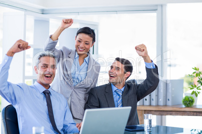 Happy business people cheering together Happy business people cheering together