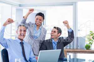 Happy business people cheering together