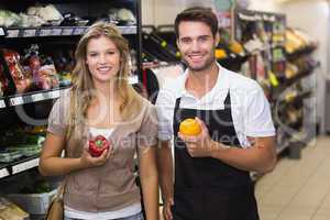 Portrait of smiling pretty blonde woman buying a vegetable at se