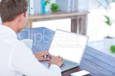 Back view of a businessman typing on laptop