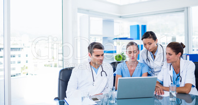 Team of doctors looking at laptop