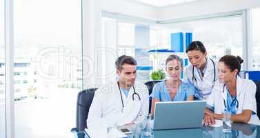 Team of doctors looking at laptop
