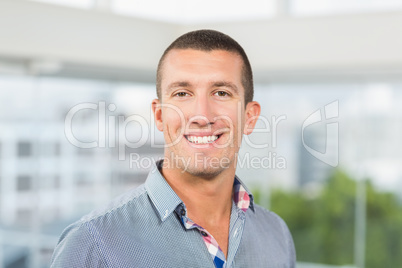 Smiling businessman in grey shirt