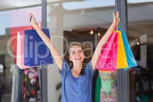 Energetic woman handing shopping bags