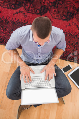 Young creative businessman typing on laptop