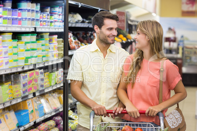 Smiling bright couple buying products