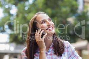 Pretty brunette having a phone call and looking away