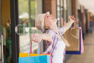 Carefree woman holding shopping bags