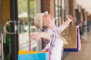 Carefree woman holding shopping bags