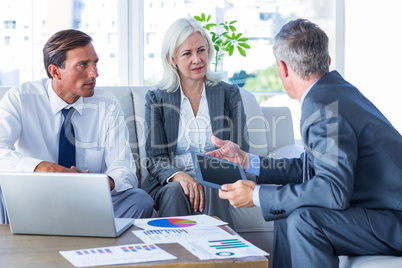 Business people speaking together on couch