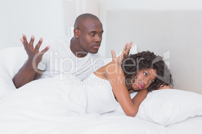 Dispute between a couple in bed together