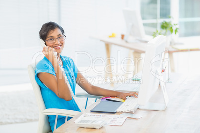 Casual designer working at her desk