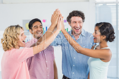 Casual business team high fiving