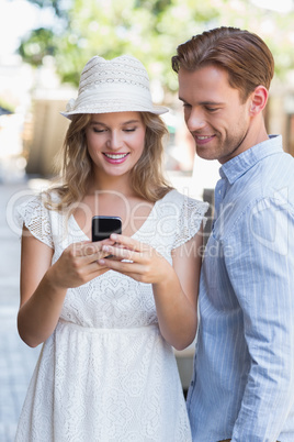Cute couple sending a text message