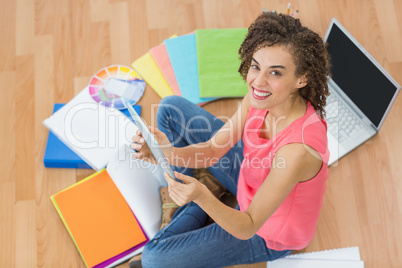 Young creative businesswoman holding a tablet
