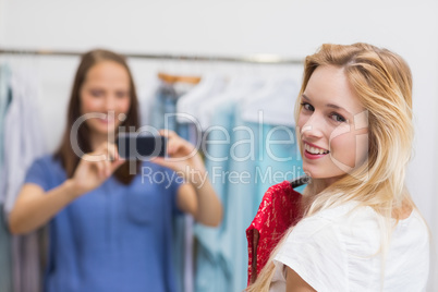 Pretty brunette photographing her friend