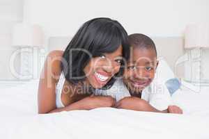 Portrait of a pretty mother with his son in bed