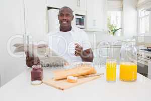 Smiling man taking his breakfast