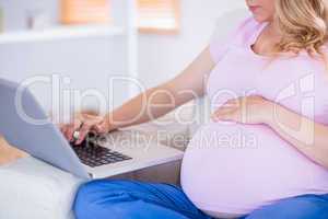 Pregnant woman using her laptop